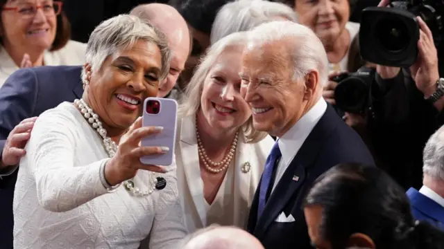 U.S. President Joe Biden poses for a selfie as he arrives to deliver the State of the Union address to a joint session of Congress in the House Chamber of the U.S. Capitol in Washington, U.S., March 7, 2024.