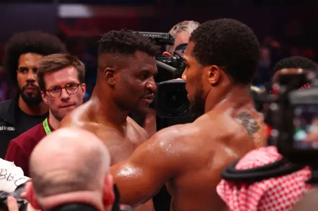 Francis Ngannou is consoled by Anthony Joshua