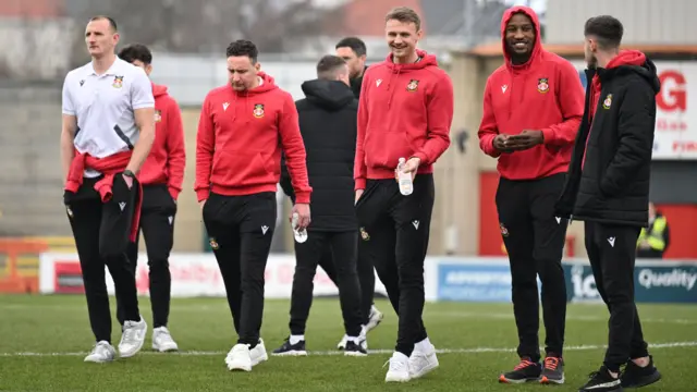 Wrexham players take a stroll on the pitch at Morecambe