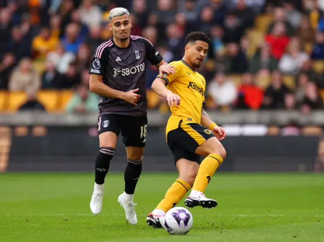 Joao Gomes is challenged by Andreas Pereira