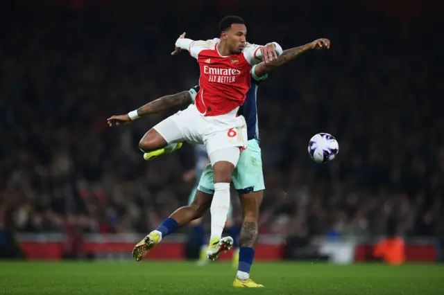 Gabriel and Ivan Toney battle for the ball