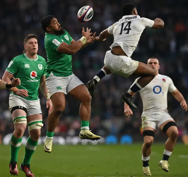 Two players contesting for the ball in the air