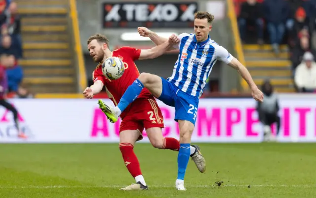 Kilmarnock's Marley Watkins and Aberdeen's Nicky Devlin in action during a Scottish Cup Quarter Final match between Aberdeen and Kilmarnock at Pittodrie Stadium, on March 09, 2024, in Aberdeen, Scotland.