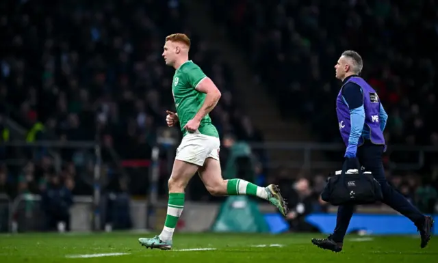 Crowley running off the pitch with medic for HIA