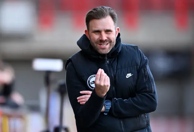 Mikey Harris gestures on the touchline.