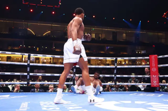 Anthony Joshua stands over Francis Ngannou