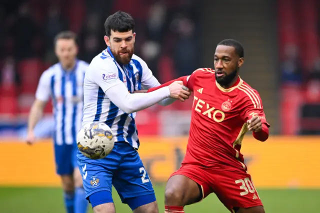 Kilmarnock's Liam Donnelly and Aberdeen's Junior Hoilett in action during a Scottish Cup Quarter Final match between Aberdeen and Kilmarnock at Pittodrie Stadium, on March 09, 2024, in Aberdeen, Scotland.