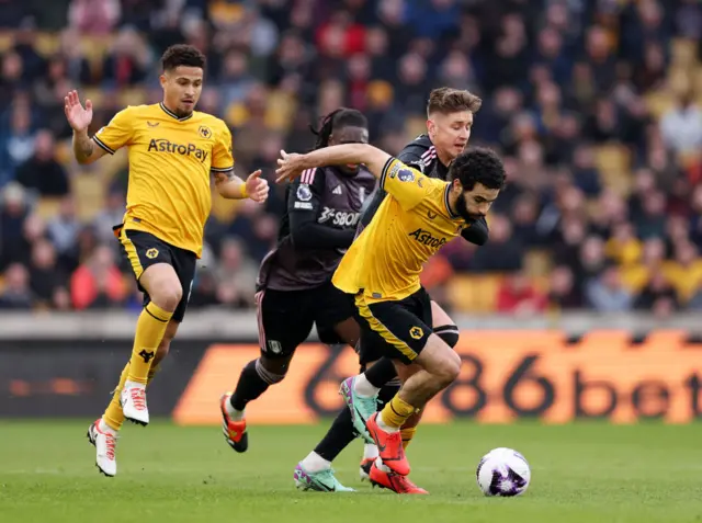 Rayan Ait-Nouri is challenged by Tom Cairney