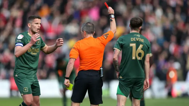 Alfie Devine is shown a red card