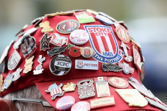 Stoke hat with pin badges covering it