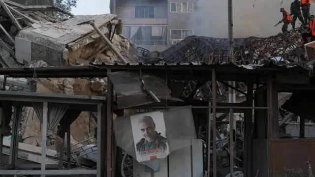 A picture of late senior Iranian military commander General Qassem Soleimani hangs amid rubble after what Syrian and Iranian media described as an Israeli air strike on Iran's consulate in Damascus