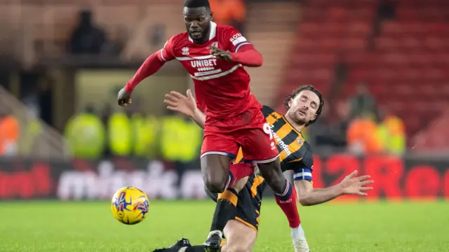 Emmanuel Latte Lath pulls away from Lewie Coyle as Hull take on Middlesbrough