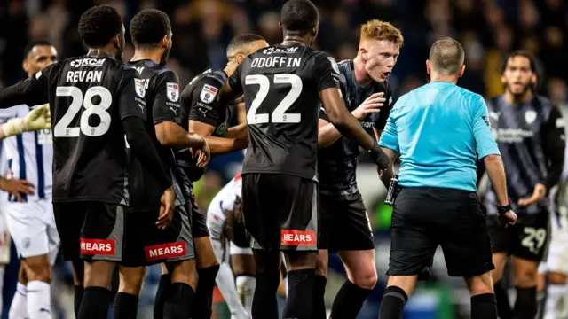 Rotherham players protest at referee