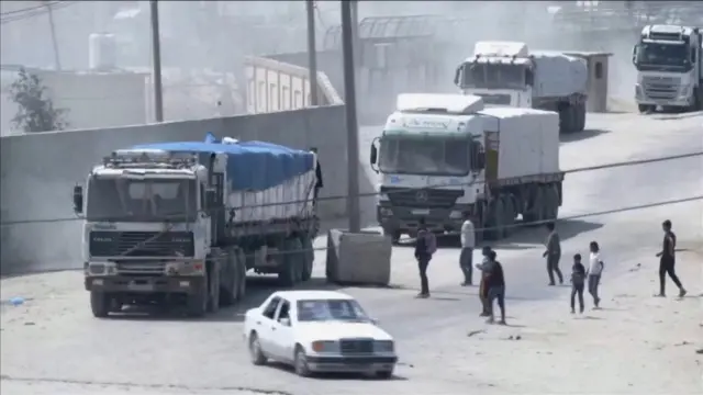 A convoy of aid trucks drives into Gaza from the Rafah crossing on 9 April