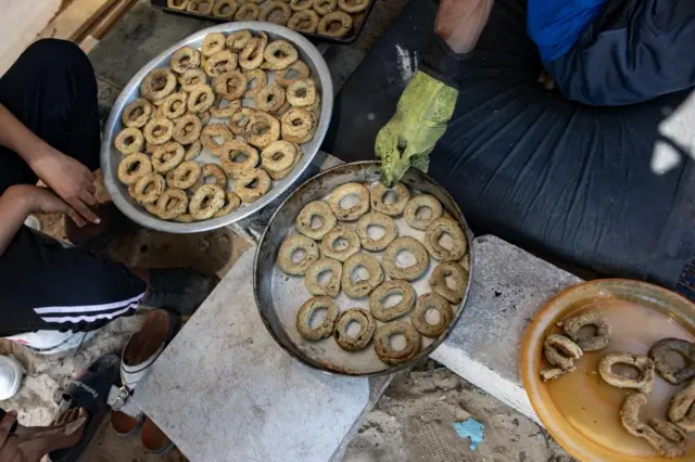 Palestinians bake cakes to mark the end of Eid al-Fitr in southern Rafah, Gaza on 9 April