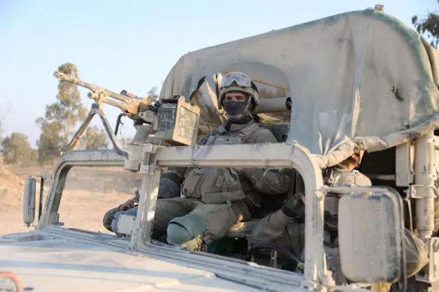 Israeli soldiers at a checkpoint along the border with Gaza in southern Israel