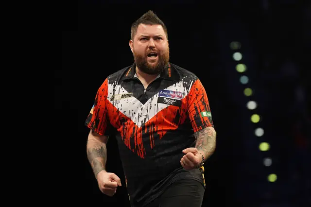 Michael Smith celebrates beating Gerwyn Price