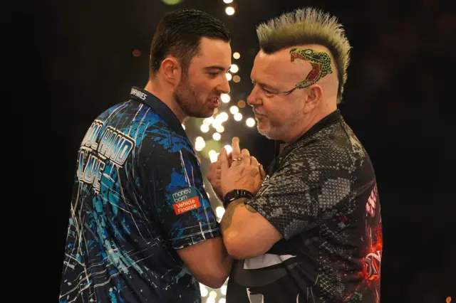 Luke Humphries and Peter Wright embrace