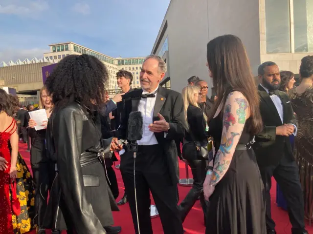 Dr Mick Donegan at the red carpet wearing a tux