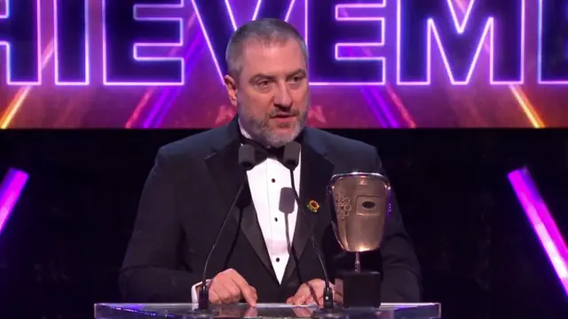 Man collects BAFTA Games Award for technical achievement on behalf on Nintendo