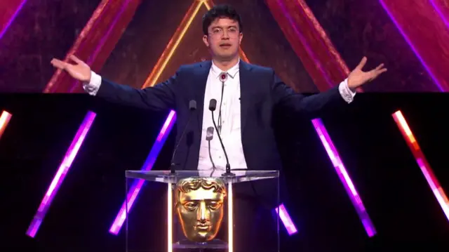 Host of Bafta Games Awards Phil Wang talking on stage