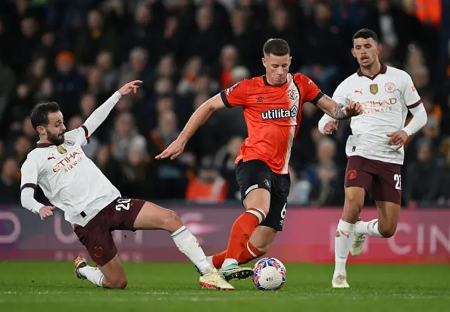 Ross Barkley of Luton Town is challenged by Bernardo Silva