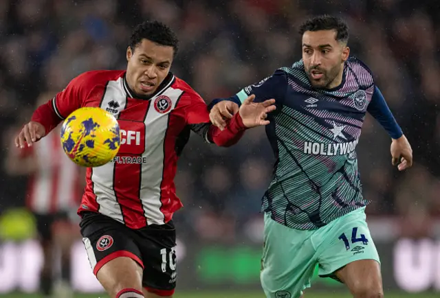 Cameron Archer of Sheffield United and Saman Ghoddos of Brentford in action