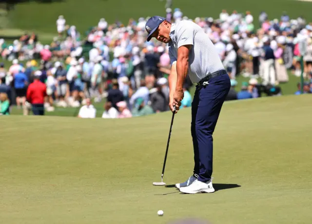 Bryson DeChambeau holes a putt