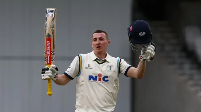 Harry Brook raises his bat after Yorkshire ton