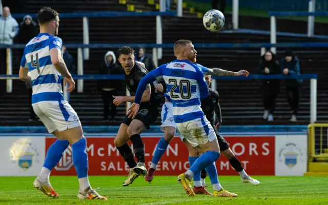 Dundee United's Ross Docherty scores with a header