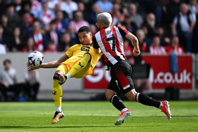 Mason Holgate of Sheffield United is challenged by Neal Maupay