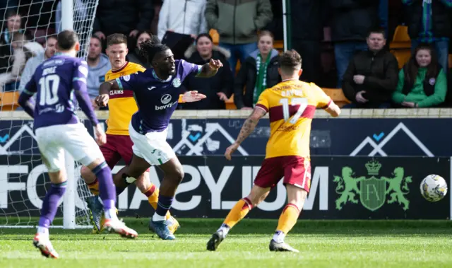 Hibs Rocky Bushiri goes down in the box under a challenge from Motherwell's Blair Spittal during a cinch Premiership match between Motherwell and Hibernian