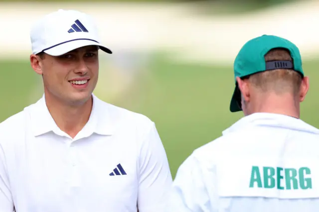 Ludvig Aberg smiles at his caddie during the 2024 Masters