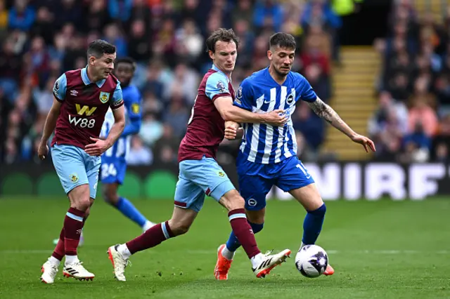 Jakub Moder of Brighton & Hove Albion is put under pressure by Sander Berge and Hjalmar Ekdal