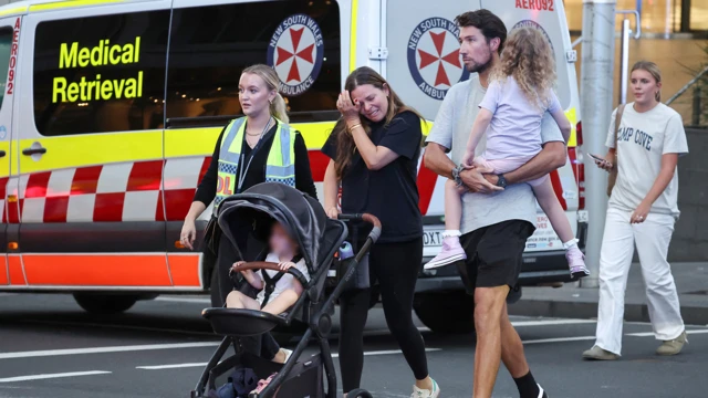 Children and mother cry outside Westfield shopping centre