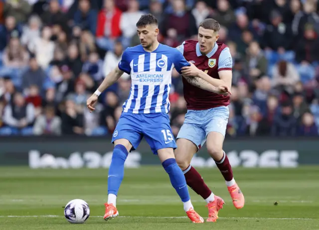 Jakub Moder (left) and Burnley's Maxime Esteve battle for the ball