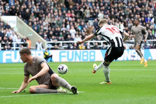 Anthony Gordon scores inside the box as Micky van de Ven lays on the turf