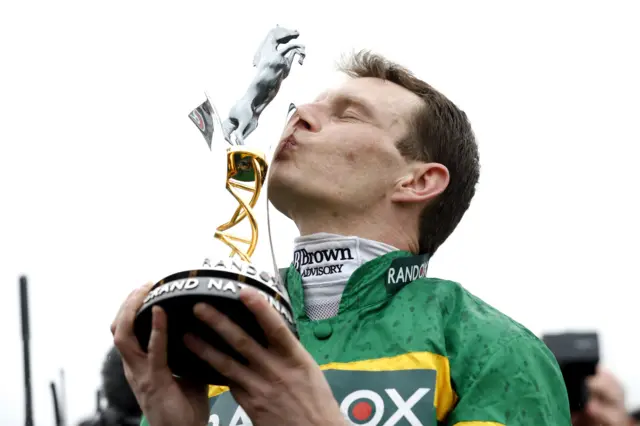 Winning jockey Paul Townend kisses the Grand National trophy