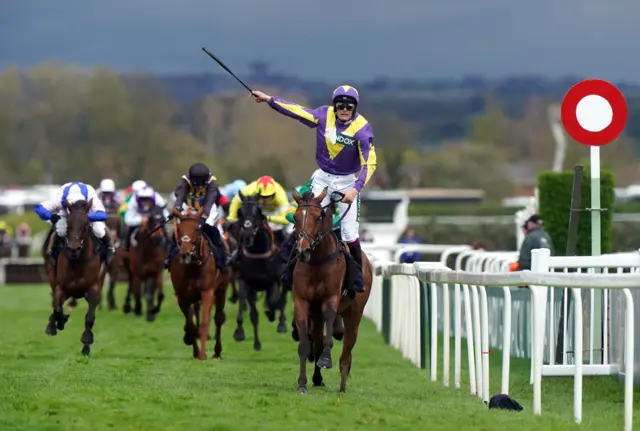 Gweenie May Boy crosses the line to win the William Hill Handicap Hurdle at Aintree as jockey Charlie Todd celebrates