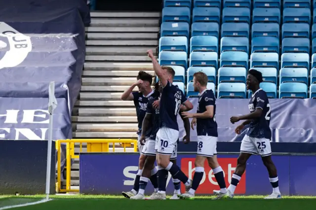 Millwall players celebrate their first goal against Millwall