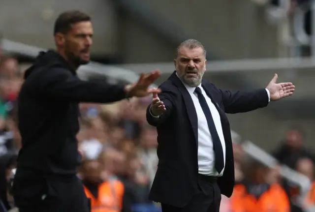 Ange Postecoglou and Newcastle United assistant manager Jason Tindall react