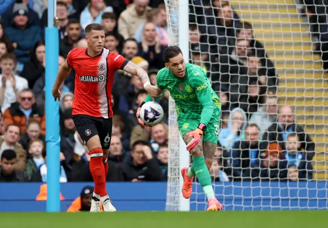 Ross Barkley in action with Manchester City's Ederson