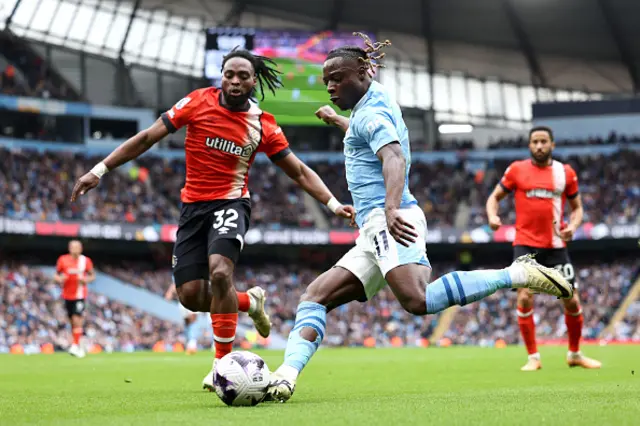 Jeremy Doku of Manchester City controls the ball whilst under pressure from Fred Onyedinma