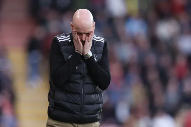 Ten Hag reacts by covering his face