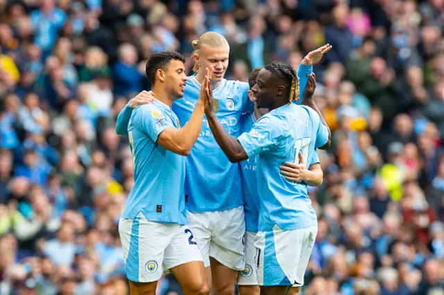 rling Haaland, wearing the number 9 jersey for Manchester City, is celebrating his goal with teammates