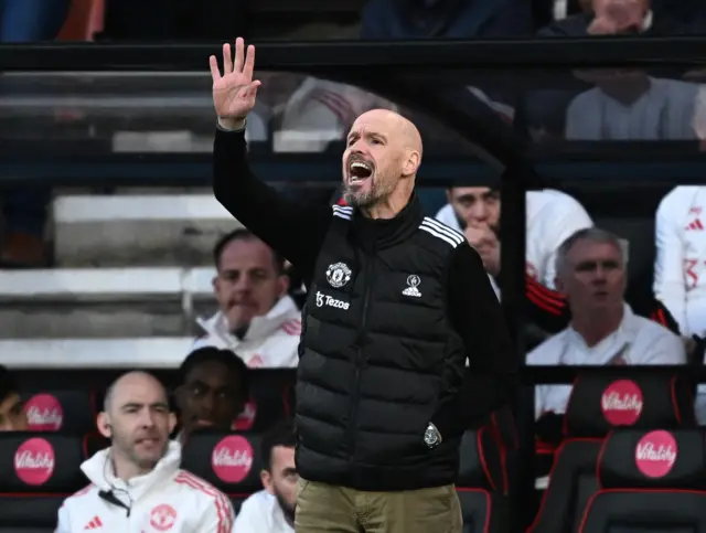 Ten Hag waves his hand and shouts from the bench