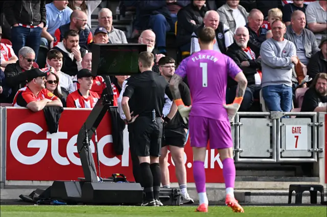 The referee looks at the VAR screen