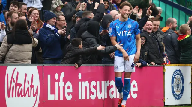 Fraser Horsfall of Stockport County celebrates scoring their second goal