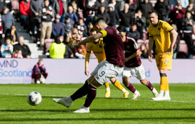 Lawrence Shankland crashes in a penalty for Hearts