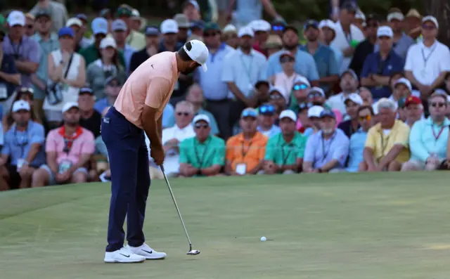 Scottie Scheffler holes a birdie putt on 16